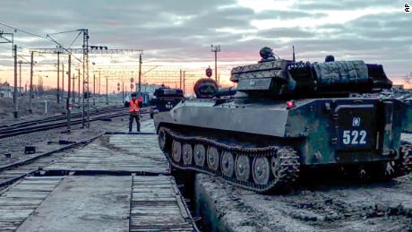 In this photo taken from video provided by the Russian Defense Ministry on Tuesday, Russian armored vehicles are loaded onto railway platforms after the end of military drills. 