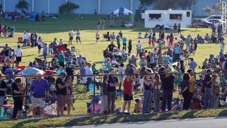 Kennedy Space Center employees and their families gather to watch the stack of NASA's Artemis rockets move.