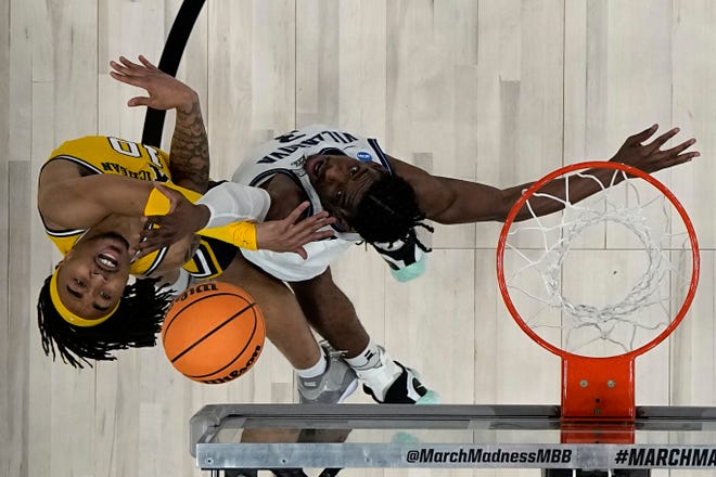 Michigan guard Frankie Collins, left, and Villanova forward Brandon Slater battle for the ball during the first half of a Sweet 16 game in San Antonio.