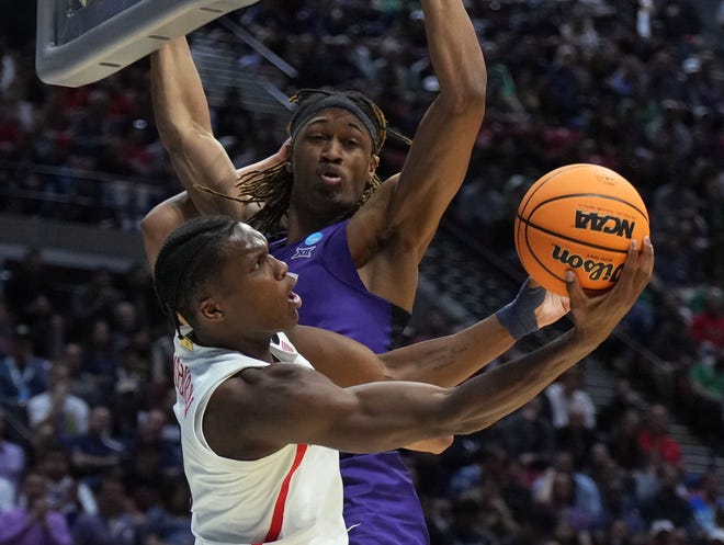 Round two: Arizona guard Benedict Mathurin (0) leads a corner kick in front of TCU defender Damion Baugh (10) during the Wildcats' thrilling 85-80 win.