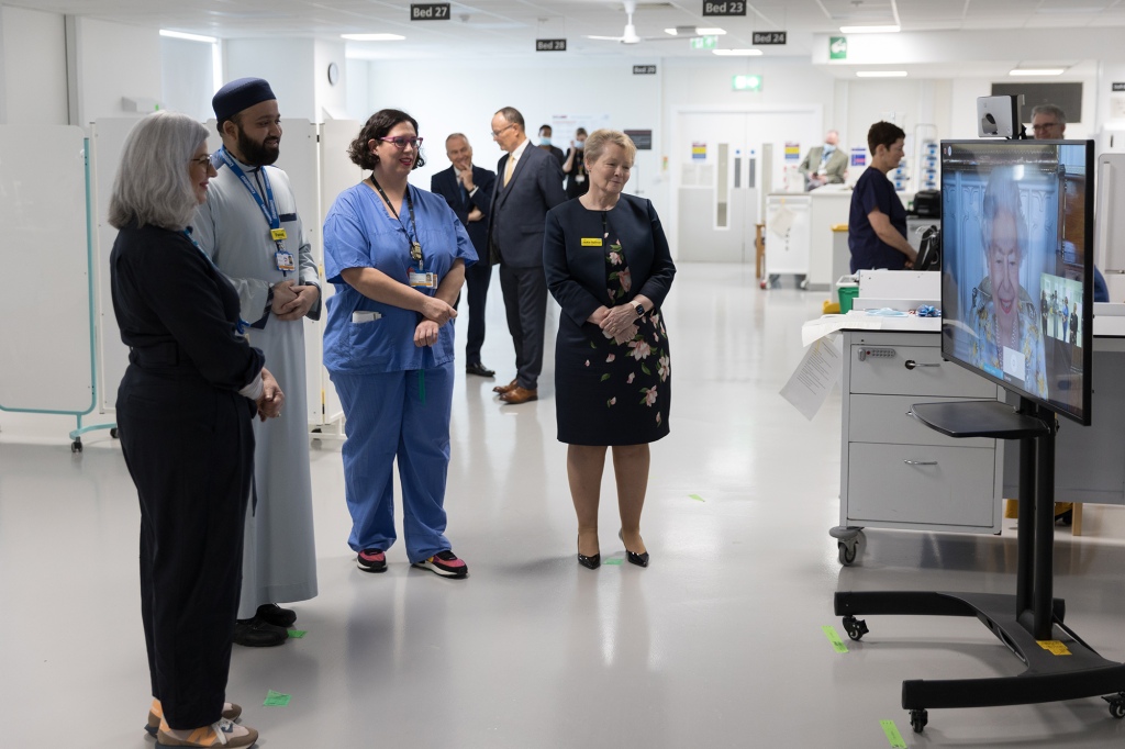 NHS staff listen to Queen Elizabeth during the video call to commemorate the opening of the Queen Elizabeth unit at the hospital.