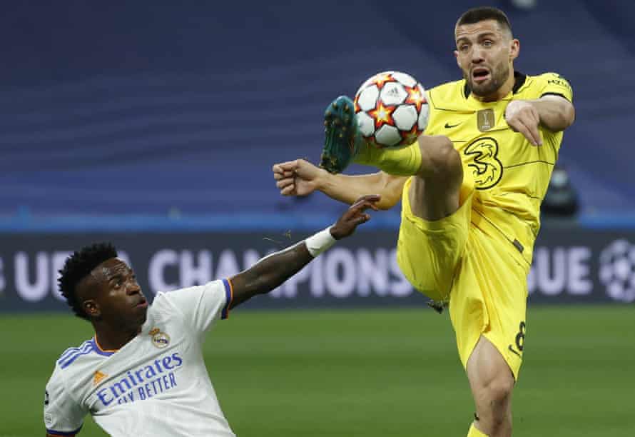 Real Madrid's Vinicius Junior (left) gets hit on the ball by Chelsea midfielder Mateo Kovacic.
