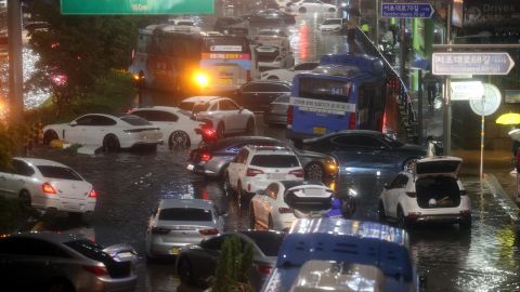 Abandoned cars fill a road in a flooded area during heavy rain in Seoul, South Korea, on August 8.