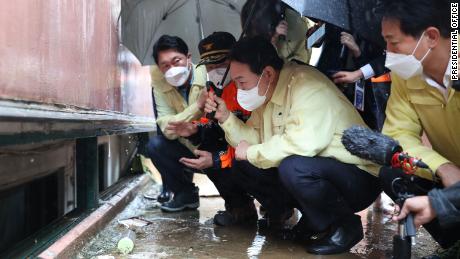 South Korean President Yoon Seok-yeol visits the flooded basement of Gwanak in Seoul, where a family died due to flooding, on August 10.