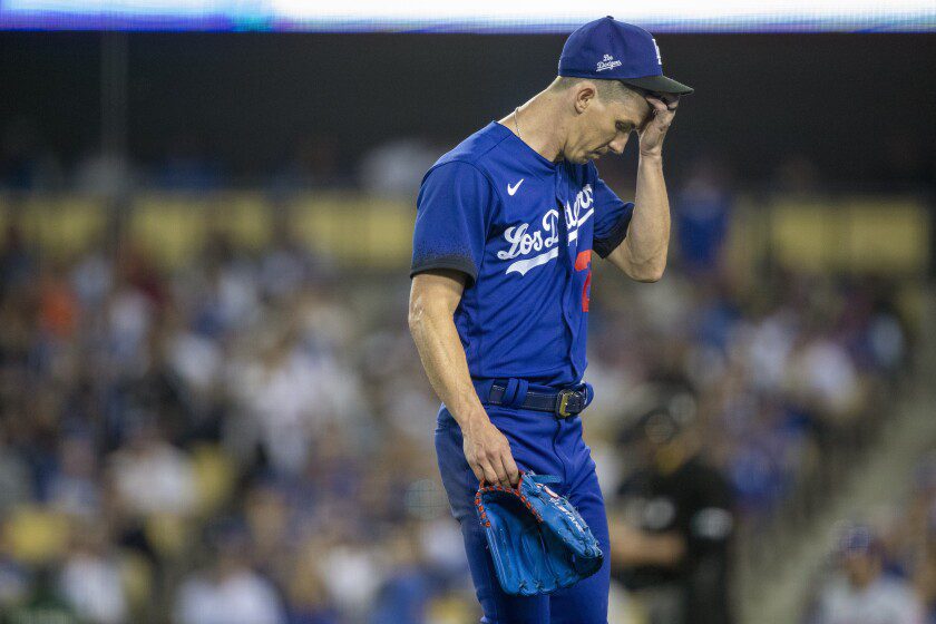 Dodgers pitcher Walker Buehler walks off the field after feeling relieved in the third inning.
