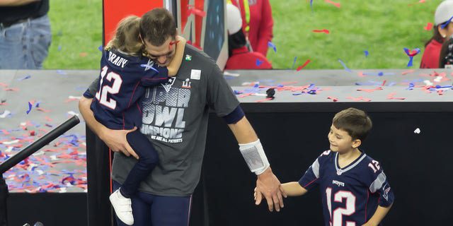 Tom Brady lifts his kids off the podium during the Super Bowl LI game between the New England Patriots and the Atlanta Falcon on February 5, 2017, at NRG Stadium in Houston, Texas. 