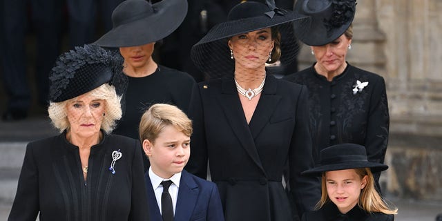 (LR) Camilla, Queen Elizabeth, Meghan, Duchess of Sussex, Prince George of Wales, Catherine, Princess of Wales, Princess Charlotte of Wales and Sophie, Countess of Wessex during the state funeral of Queen Elizabeth II at Westminster Abbey on September 19, 2022 in London. 