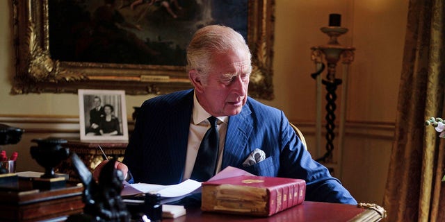 In this September 11, 2022 photo, Britain's King Charles III carries out official government duties from his Red Box in the 18th century room at Buckingham Palace, London.  (Victoria Jones/PA via AP)