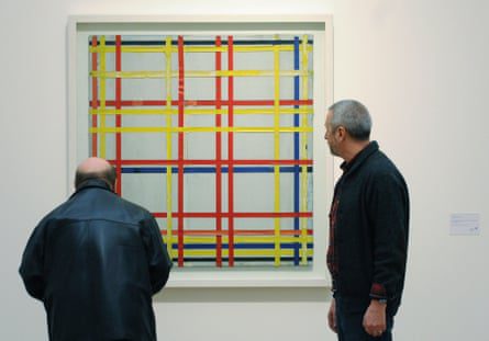 Two men inspect the first New York City painting by Piet Mondrian displayed in the exhibition Piet Mondrian - Fom Abild Zoom Bild at the Ludwig Museum in Cologne, Germany in 2007.