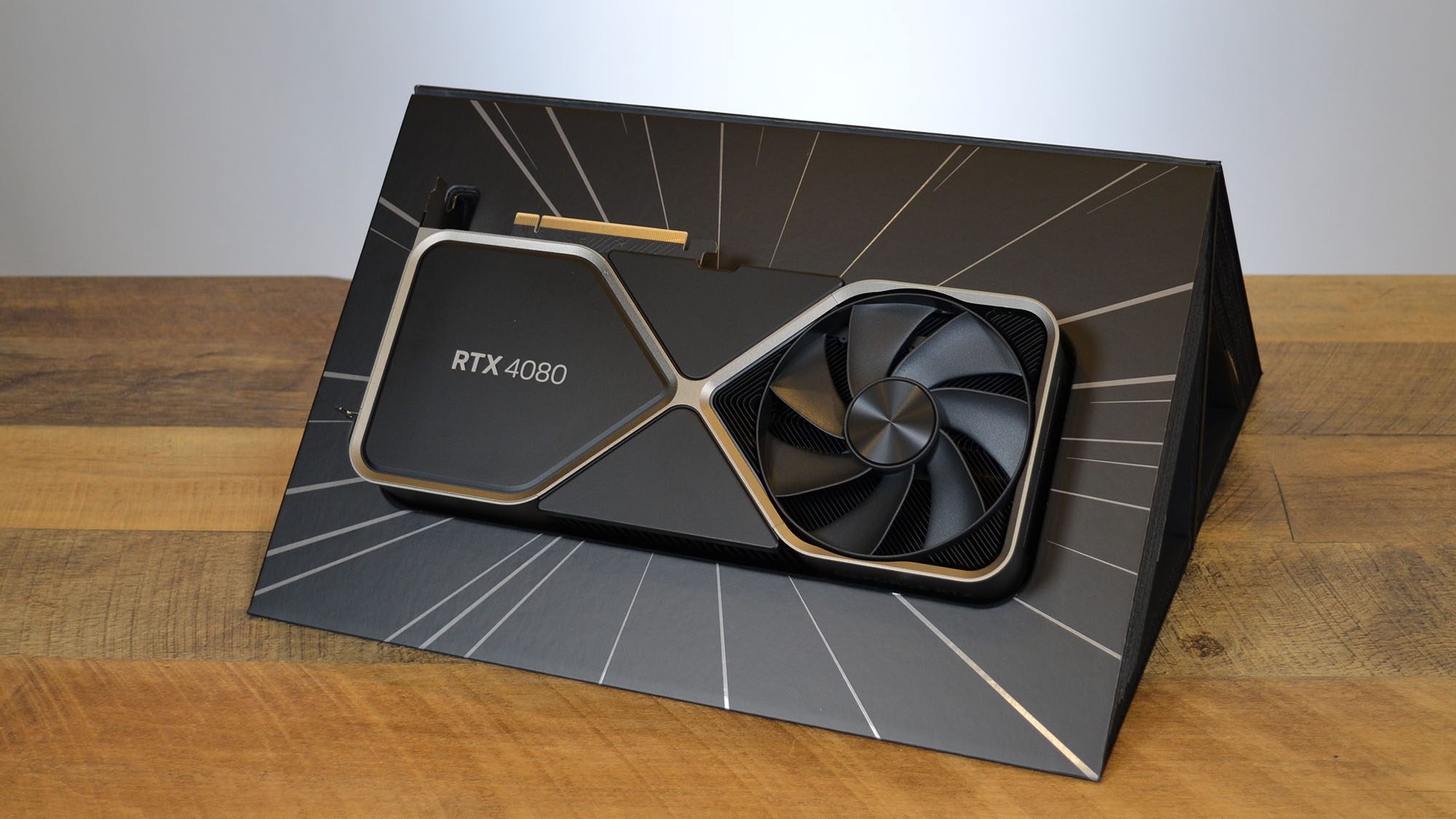 Nvidia GeForce RTX 4080 on a wooden desk in front of a white board