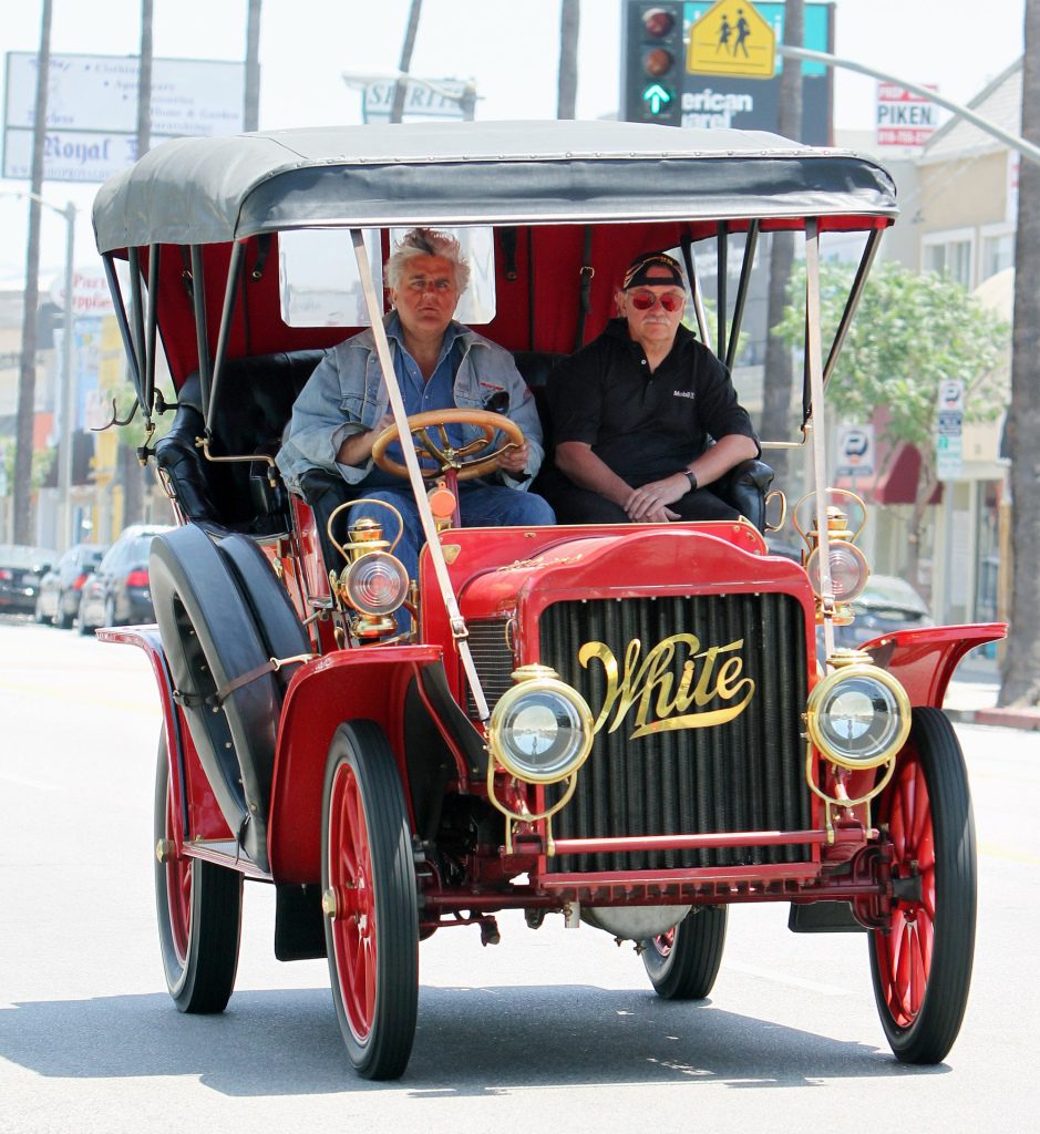 Pictures from July 2010 show Jay Leno driving around Los Angeles in his 1908 white car, which exploded in a garage fire. 