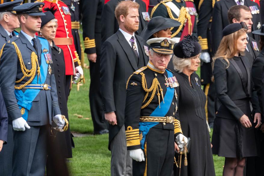 King Charles III, Queen Camilla, Prince William, Prince Harry and Meghan Markle watch the coffin of the late Queen Elizabeth II at the state funeral.