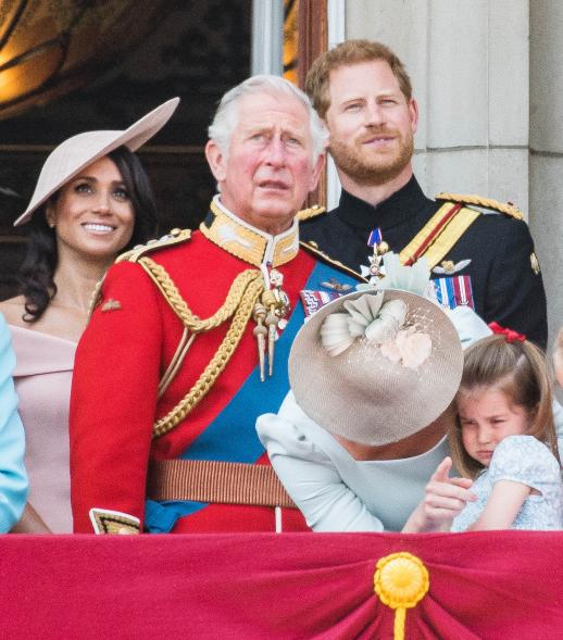 Meghan Markle, King Charles III, Prince Harry, Catherine and Princess Charlotte stand on the balcony of Buckingham Palace.
