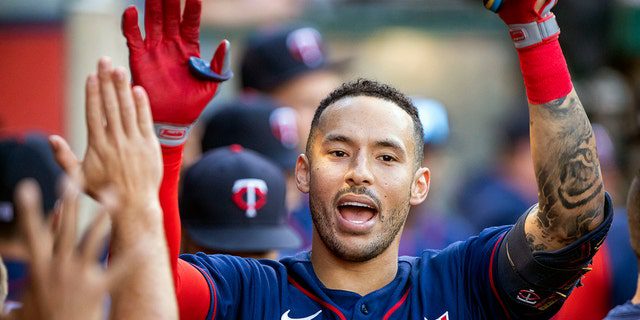 FILE - Carlos Correa of ​​the Minnesota Twins is congratulated after hitting a home run of a single in Anaheim, Calif., on Saturday, Aug. 13, 2022. 