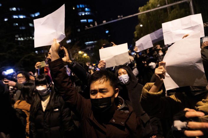 People hold white papers protesting against coronavirus disease (COVID-19) restrictions, after a vigil for fire victims in Urumqi, as the COVID-19 outbreak continues, in Beijing, China November 28, 2022. REUTERS/Thomas Peter/File Photo TPX IMAGES OF THE DAY SEARCH 